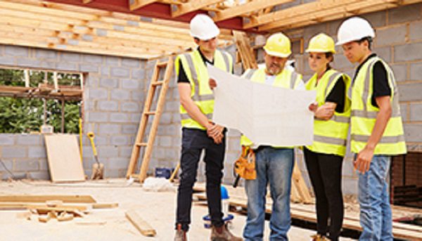 Group Professional Engineers Looking at a Blue Print