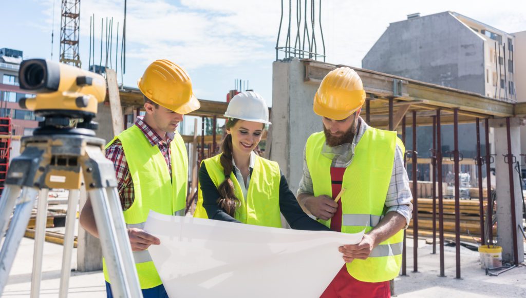Group of Professional Engineer Studying a Blue Print